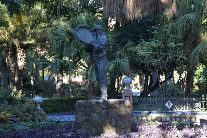 Statue Amidst Garden Palms