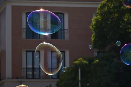 Floating Soap Bubbles Amidst City Buildings