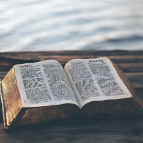 Tranquil Setting: Open Book on Deck by the Water