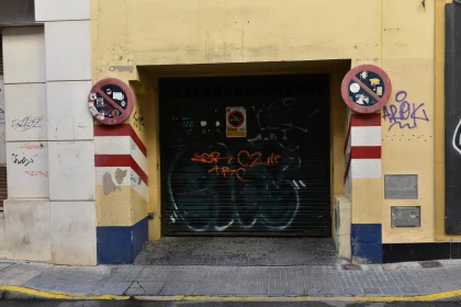 Yellow Building with Graffiti and Signs