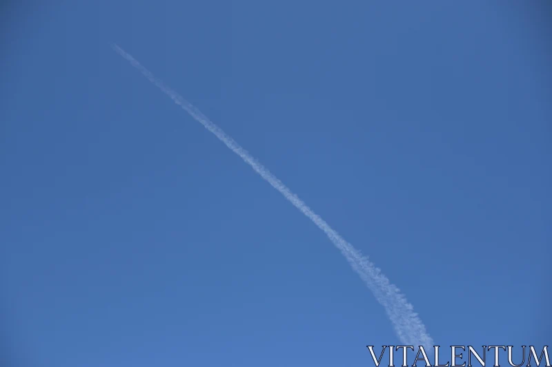 Contrail Across Blue Sky Free Stock Photo