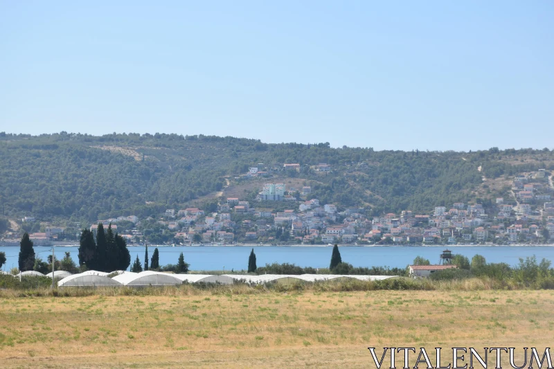 Coastal Town with Greenery and Sea Free Stock Photo