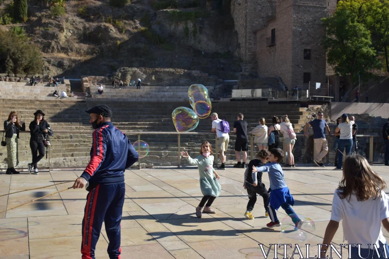 Joyful Bubble Chase in Urban Scene Free Stock Photo