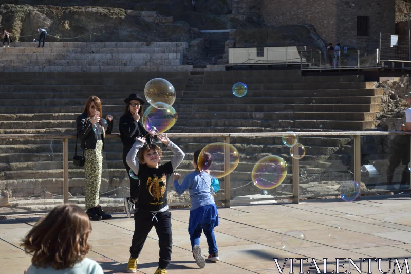 Playful Children with Bubbles Free Stock Photo