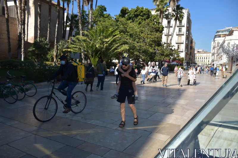 City Life with Palm Trees and People Free Stock Photo