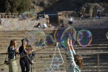 Joyful Child Reaches for Bubbles