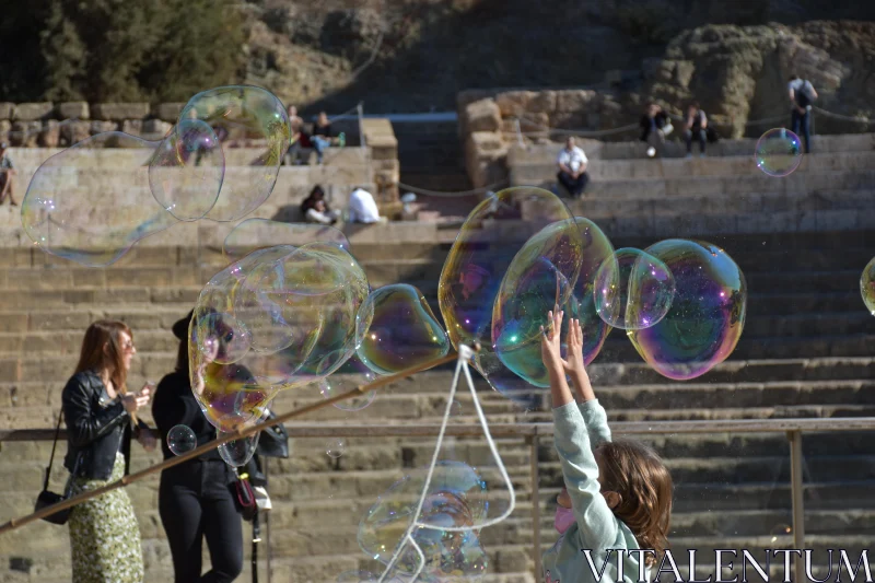 PHOTO Joyful Child Reaches for Bubbles