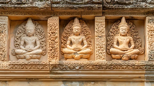 Serene Buddha Statues in Sandstone Temple Wall