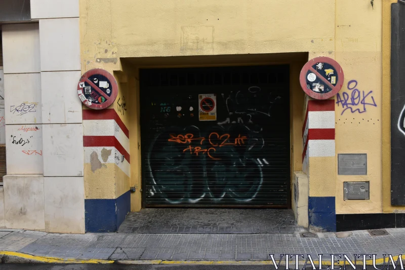 Yellow Building with Graffiti and Signs Free Stock Photo