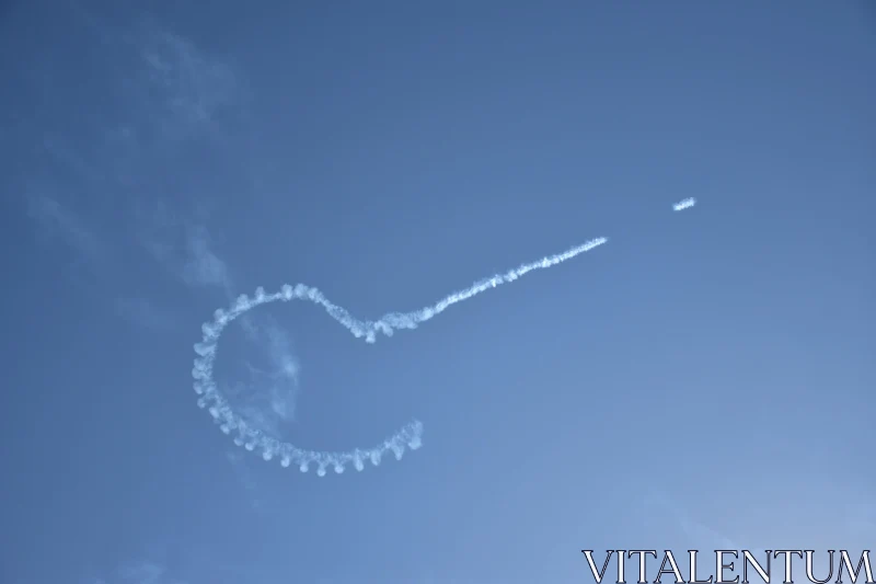 Looping Smoke Patterns in Clear Sky Free Stock Photo