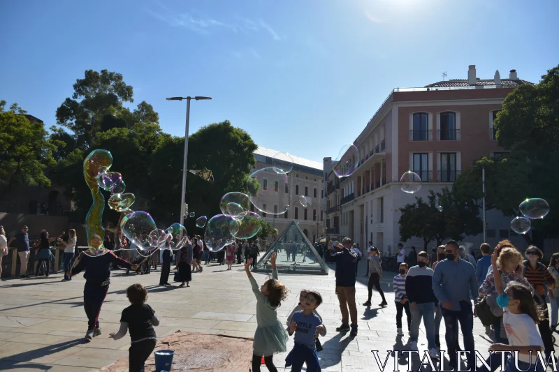 Joyful Bubble Play in Urban Setting Free Stock Photo