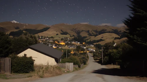 Tranquil Village at Night with Hills