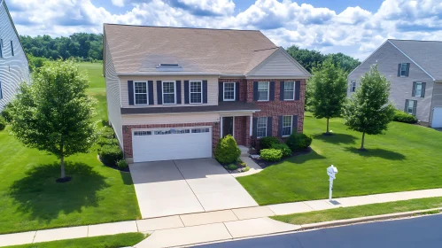 Charming Two-Story Suburban House with Clean Garage and Green Lawn