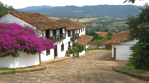 Scenic View of Colonial Village with Flowering Bougainvillea and Mountain Landscape